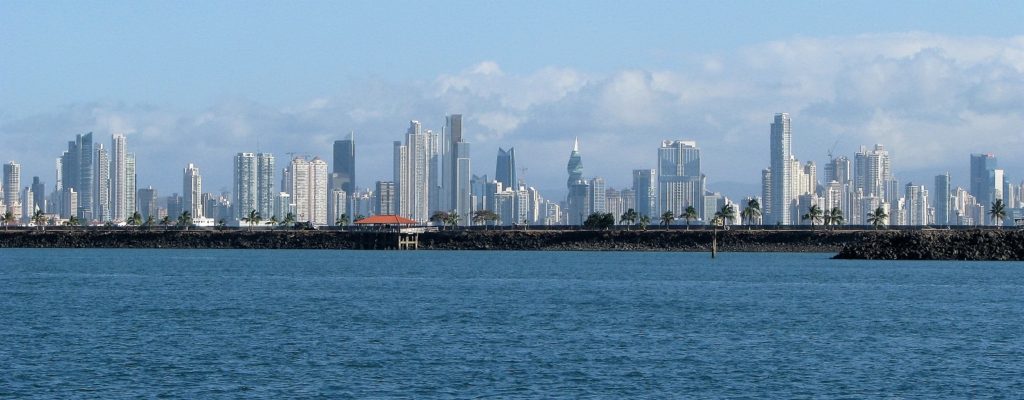 Panama City skyline with harbour and causeway in foreground.