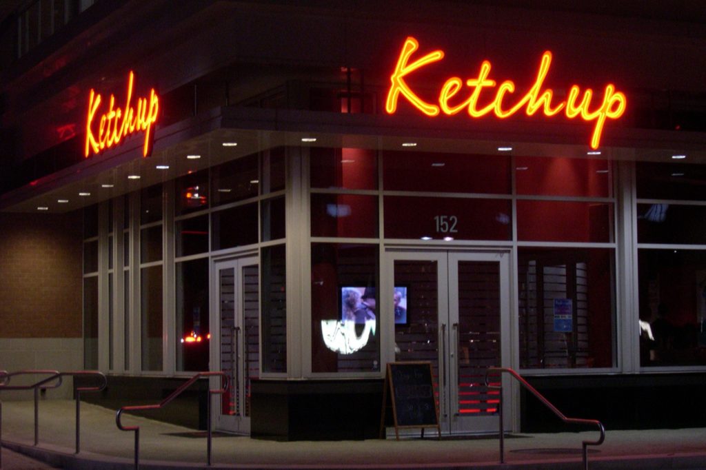 Corner view of Ketchup restaurant at night.