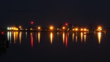 Coloured lights reflected in water of Comox Harbour.