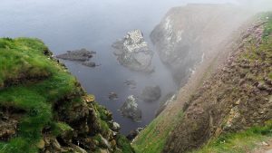 View of rocky cliffs and sea far below