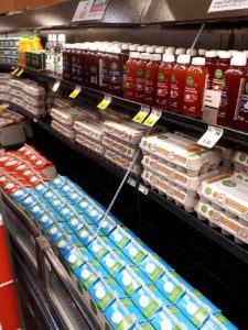 Reflection of food in a grocery-store cooler.